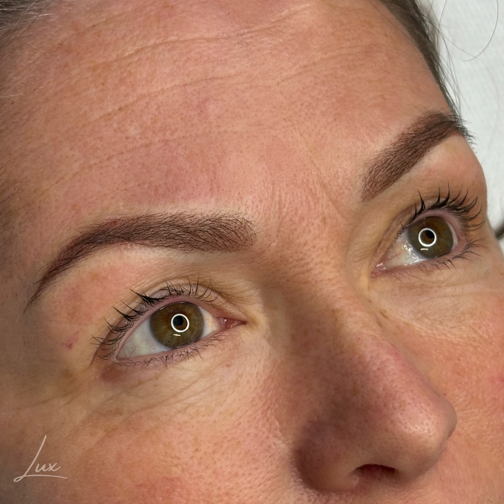 Close-up of semi-permanent powder brows showing precision and symmetry in Devon.