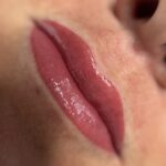 Close-up of freshly done lip blush treatment with soft pink tint