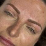 ide angle of freshly done combination brows with micro hair-strokes and blended shading